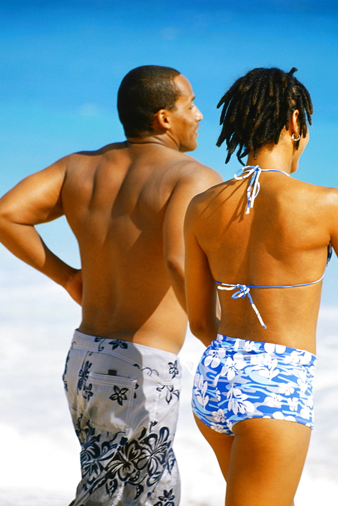 Rear view of a couple in swimsuit, Horse-shoe Bay beach, Bermuda