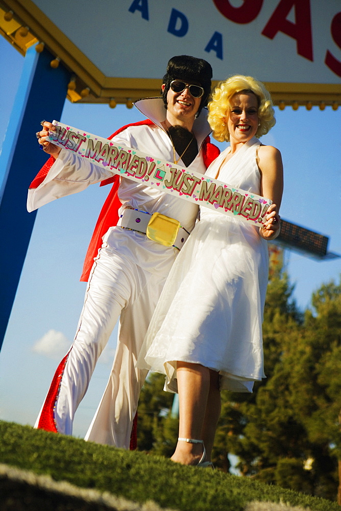 Mid adult man and a mid adult woman dressed in costumes, Las Vegas, Nevada, USA