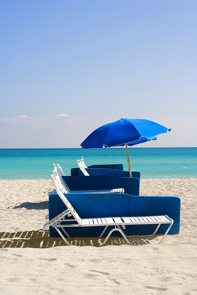 Umbrella and a lounge chair on the beach