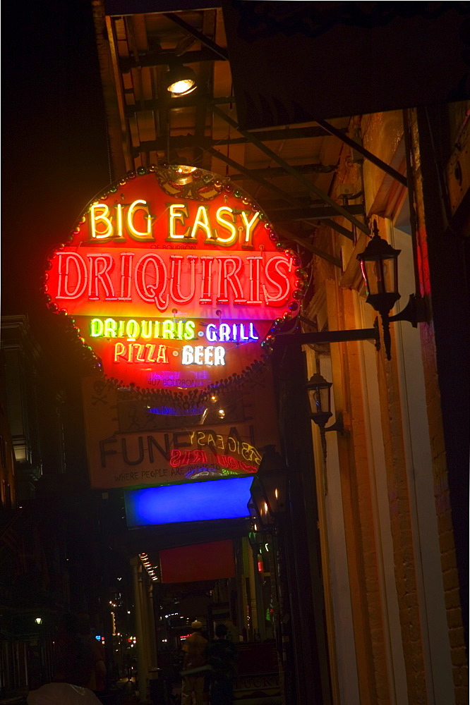 Low angle view of commercial sign lit up at night, New Orleans, Louisiana, USA