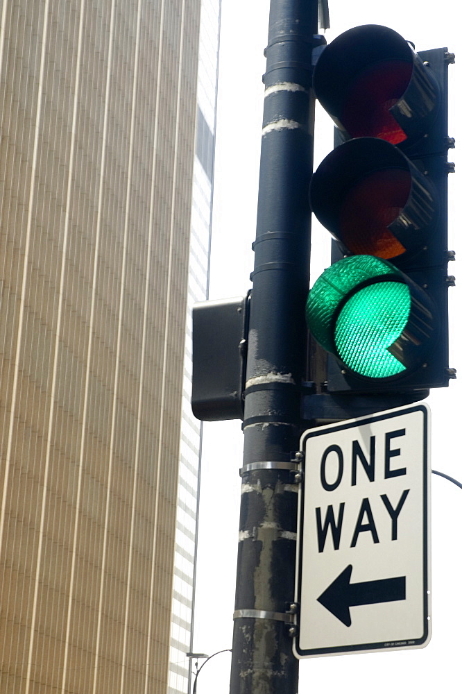 Low angle view of a directional sign on a traffic light, Chicago, Illinois, USA