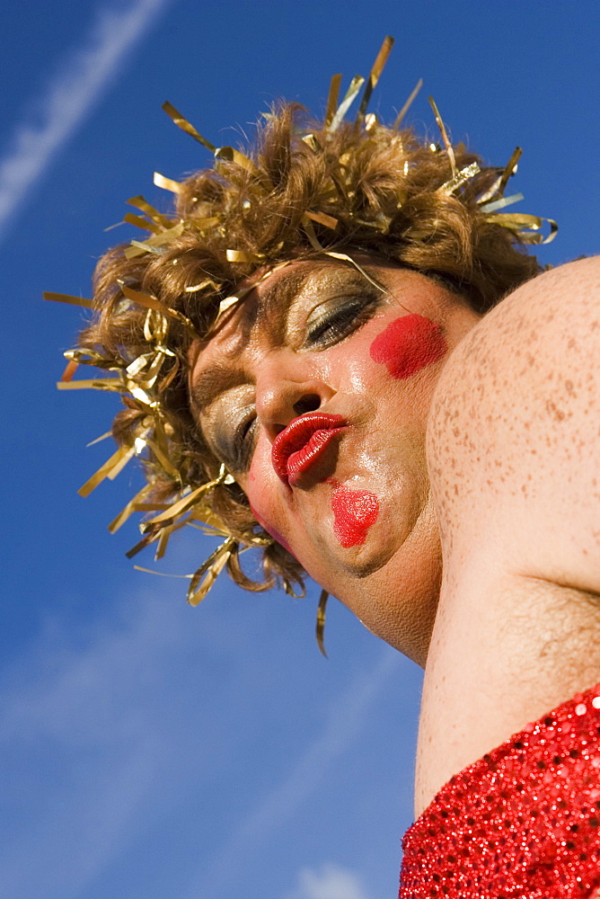 Low angle view of a mature man wearing a costume and puckering his lips