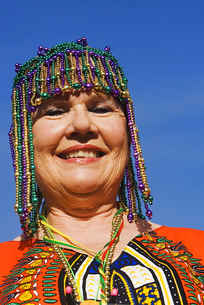 Portrait of a senior woman wearing a beaded headdress and smiling