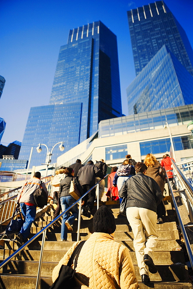 Low angle view of a large group of people walking up stairs