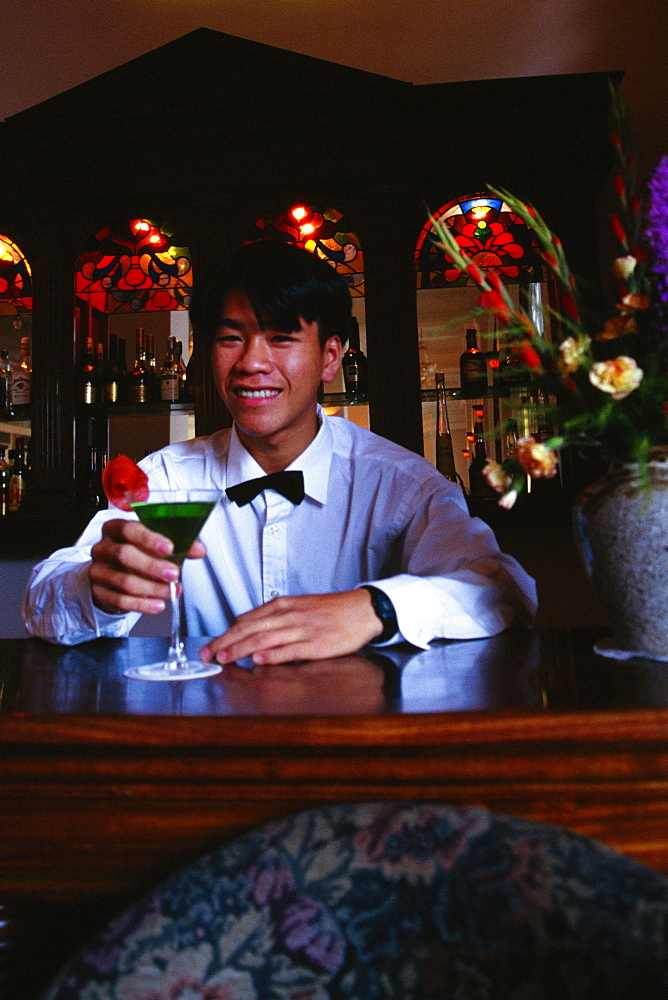 Close-up of a mid adult man holding a cocktail