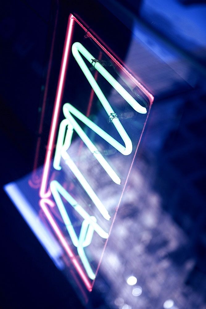 Low angle view of an ATM neon sign