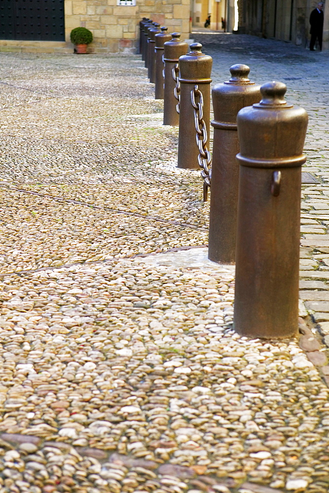 Chain-link fence on a sidewalk, Spain