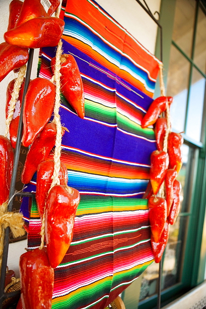 Close-up of a blanket hanging in the middle of artificial chilies, San Diego, California, USA