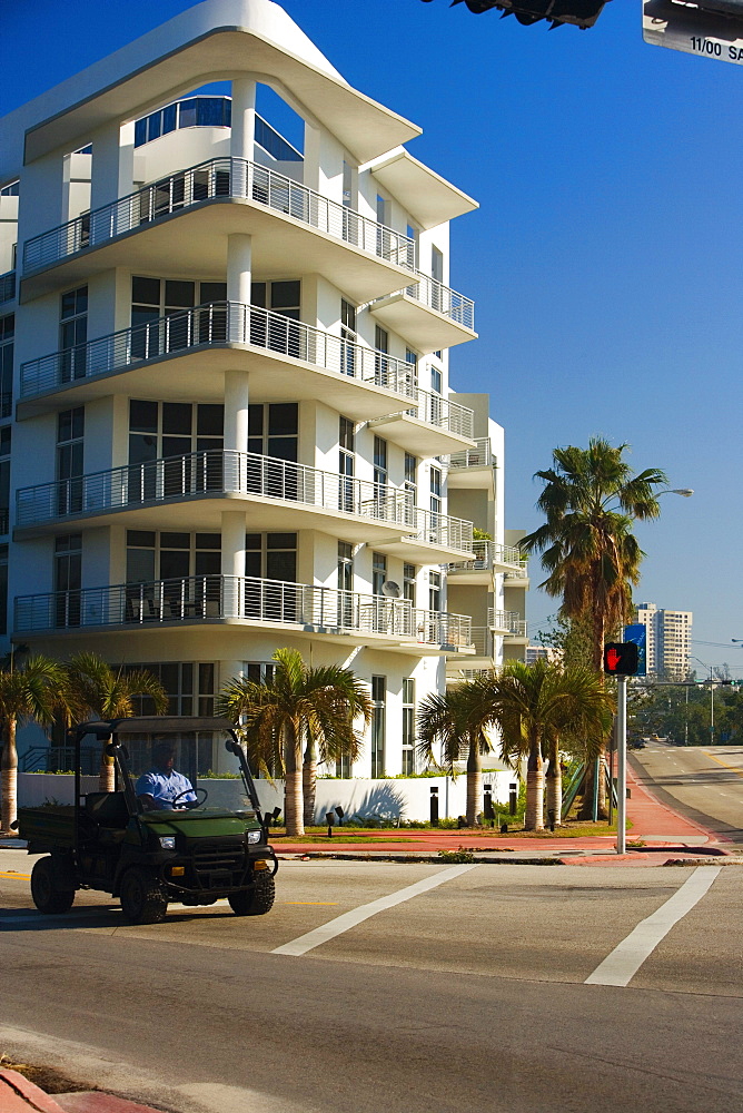 Man driving a truck in front of a multi-storeyed building, Miami, Florida, USA