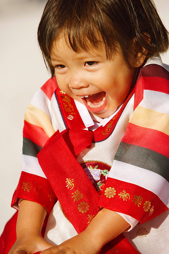 Close-up of a girl in traditional clothing laughing