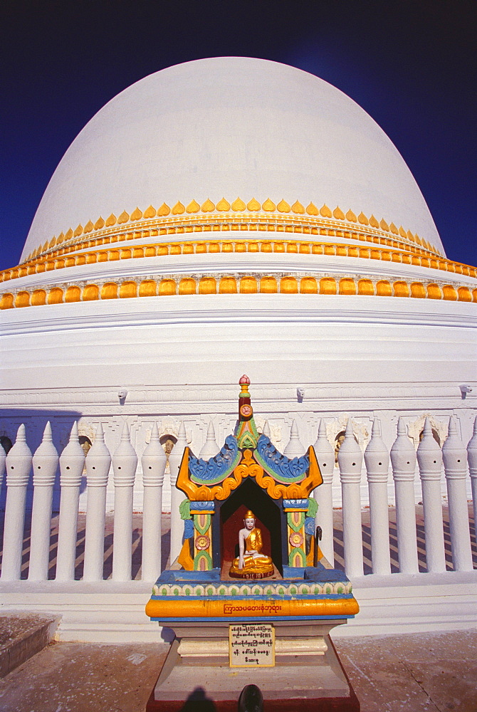 Statue of Buddha in front of a pagoda, Sagaing, Myanmar