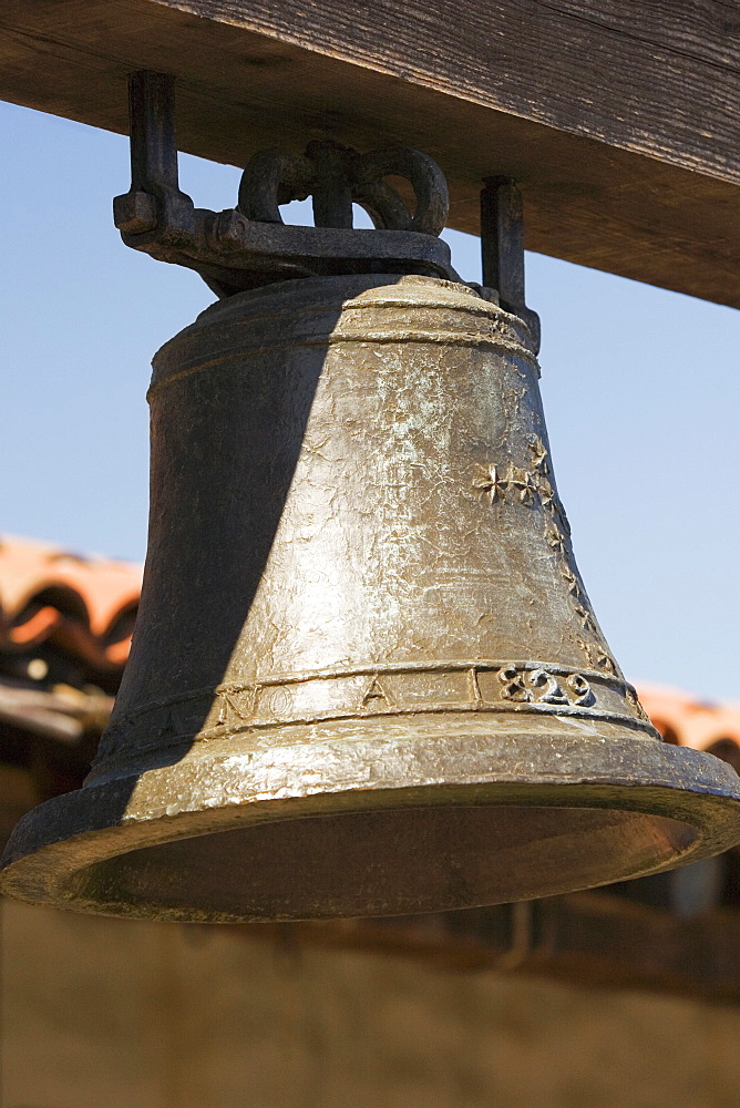 Close-up of a bell hanging in front of a house