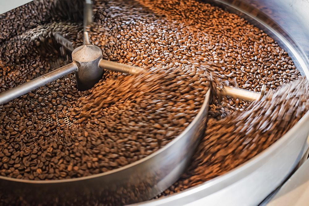 Machinery at a coffee bean processing shed roasting coffee beans, New York state, USA