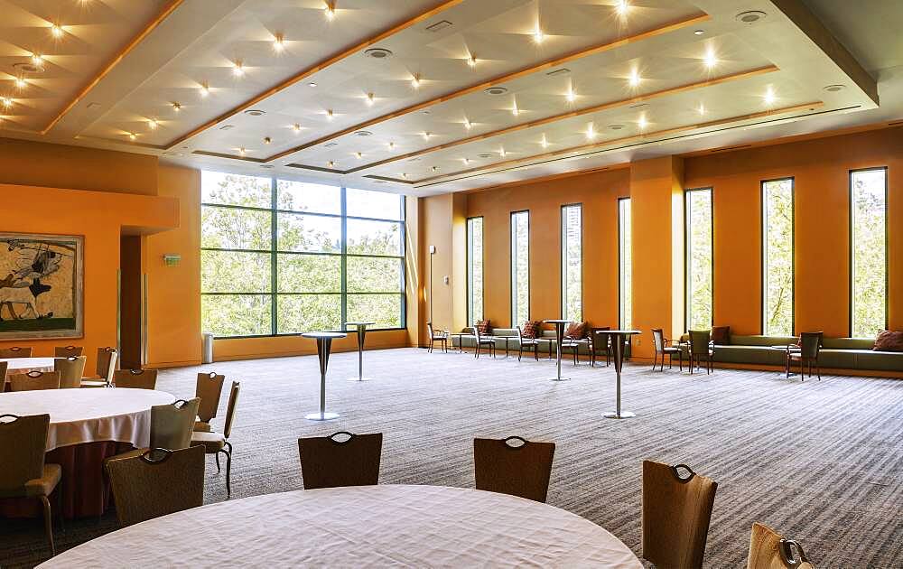 Large empty room in a hotel or conference centre, tables and chairs.