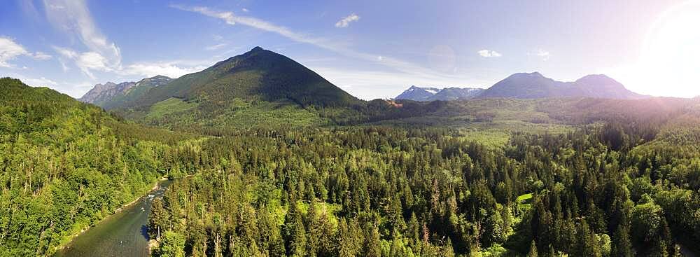 Moutain range and forests in the valley, elevated view of a majestic landscape and a wide river.