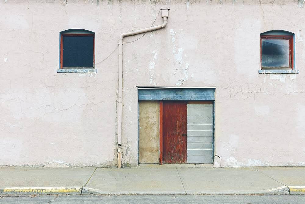 Old building with closed doors on Main Street in a town