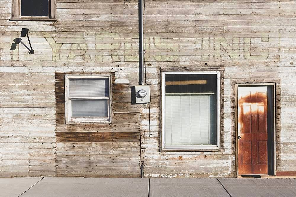 Old wooden building on Main Street, boarded up windows.