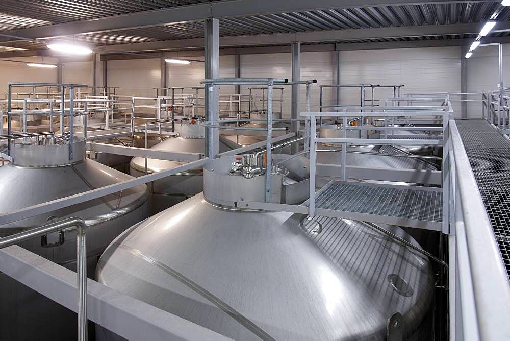 Interior of brewery, large steel storage tanks for brewing beer.