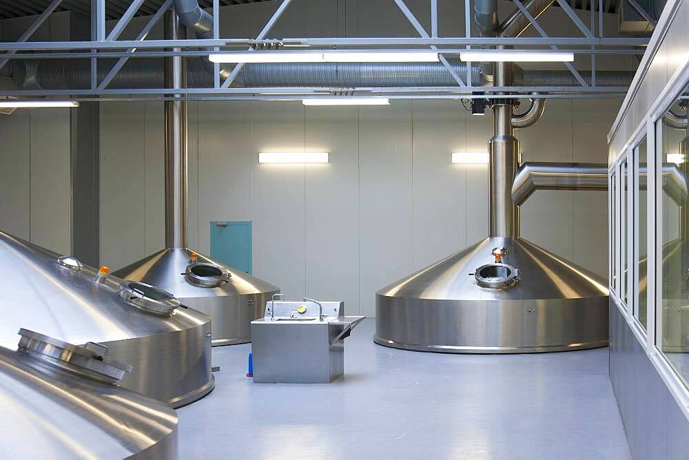 Interior of brewery, large steel storage tanks for brewing beer.