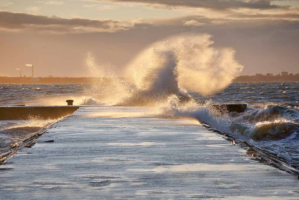 A weather storm, waves crashing over a waterfront