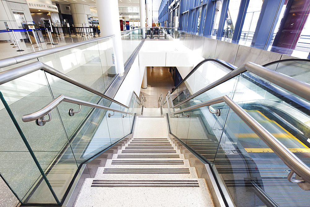 Empty airport interior, concourse and stairs and escalators