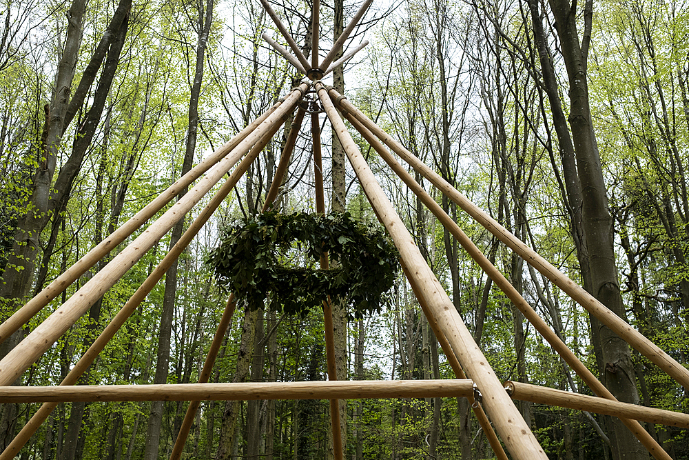 Wooden structure with wreath for a woodland naming ceremony.
