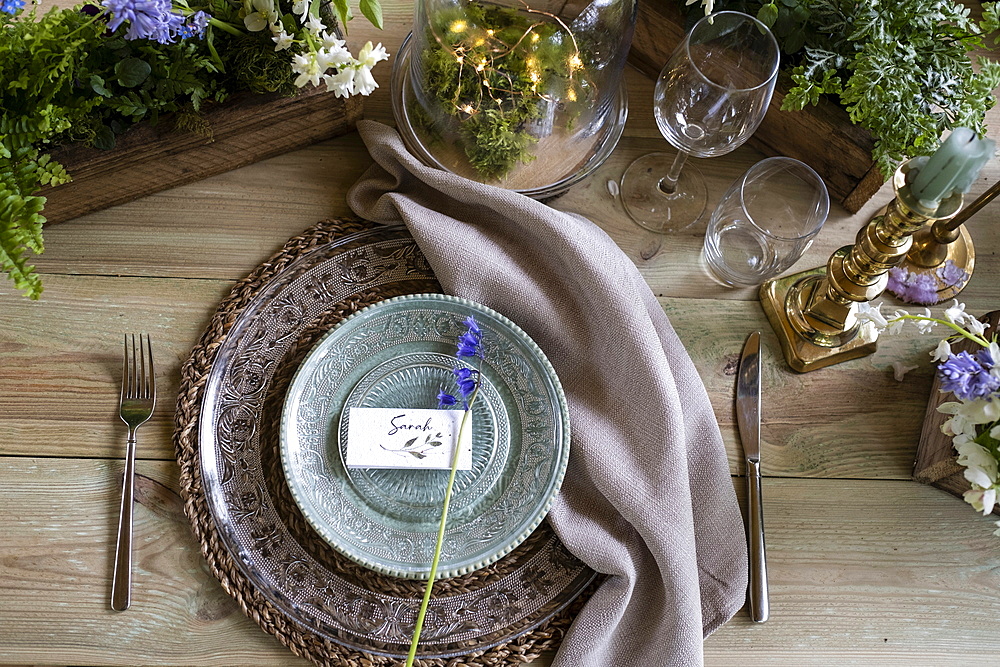 High angle close up of rustic place setting for a woodland naming ceremony.