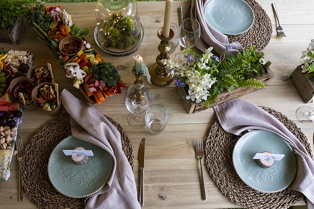 High angle close up of rustic place setting for a woodland naming ceremony.