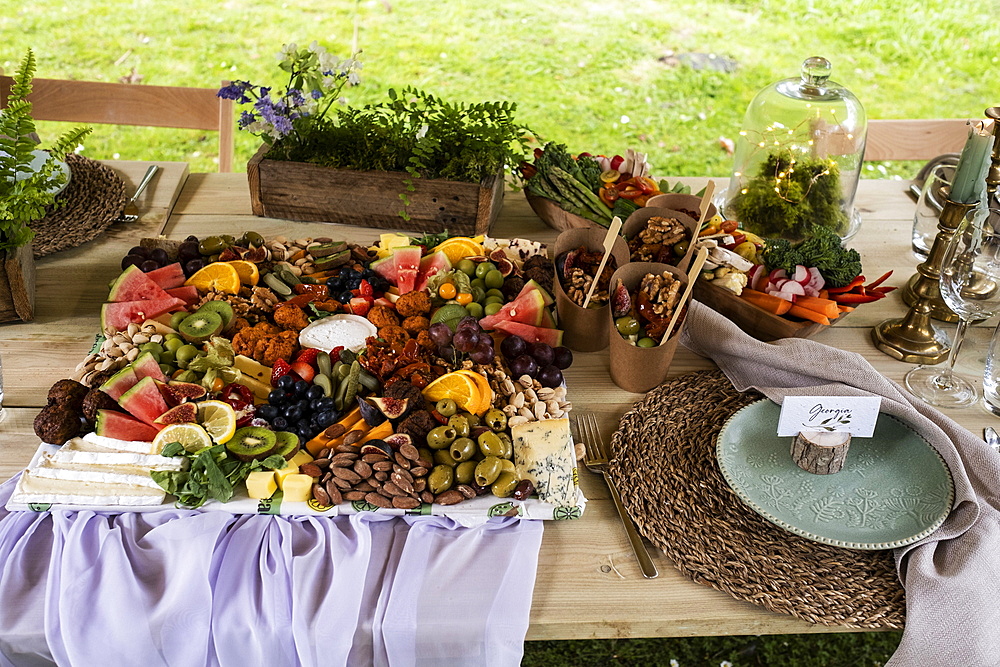 Rustic place setting for a feast and naming ceremony in a forest.