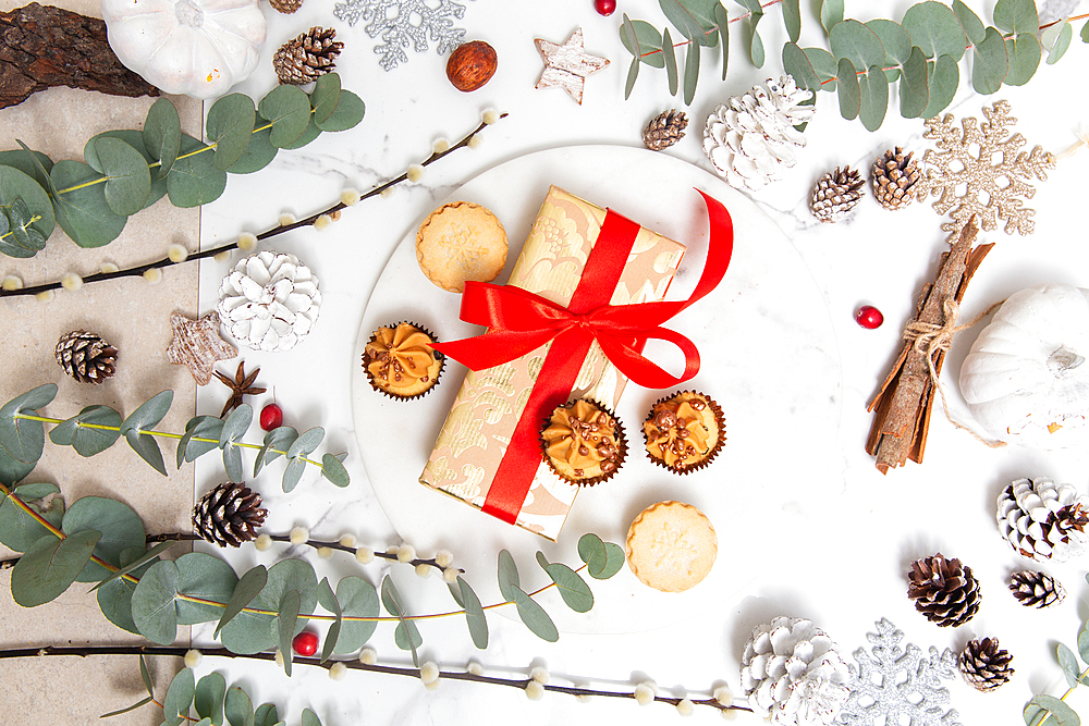 Christmas decorations on a white background, green leaves and red berries