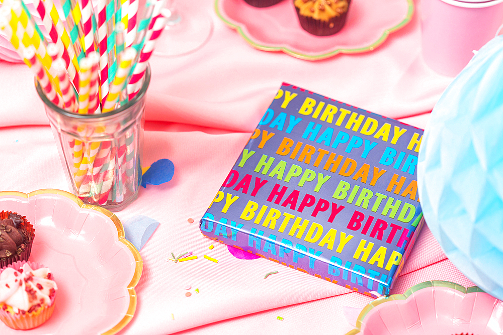 Birthday party table, with pink tablecloth