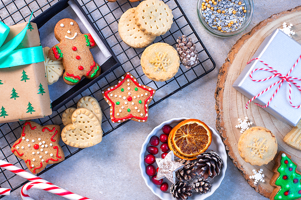 Overhead view of Christmas cookies and biscuits, and Christmas ornaments.