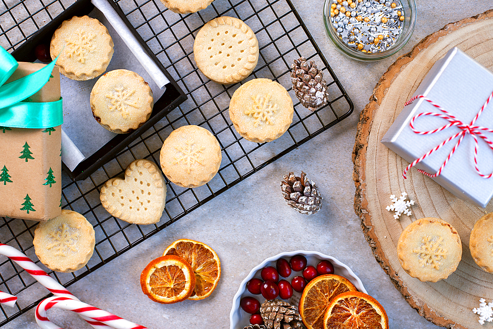 Overhead view of Christmas cookies and biscuits, and Christmas ornaments.