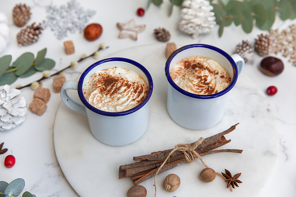 Christmas, mugs of egg nog with whipped cream and candy canes.