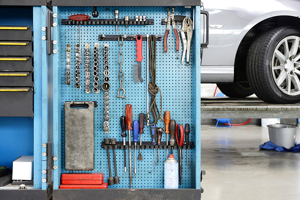 Tools in a cabinet, organised in rows, at an auto repair shop