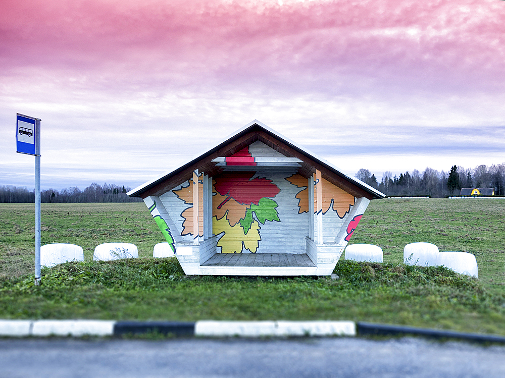 Roadside bus stop in Estonia. Hay baled in white plastic sacks.