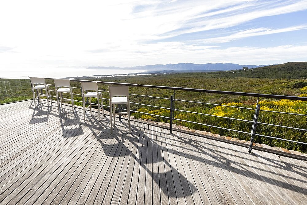 A terrace overlooking a green shrub fynbos landscape , Stanford, Western Cape, South Africa