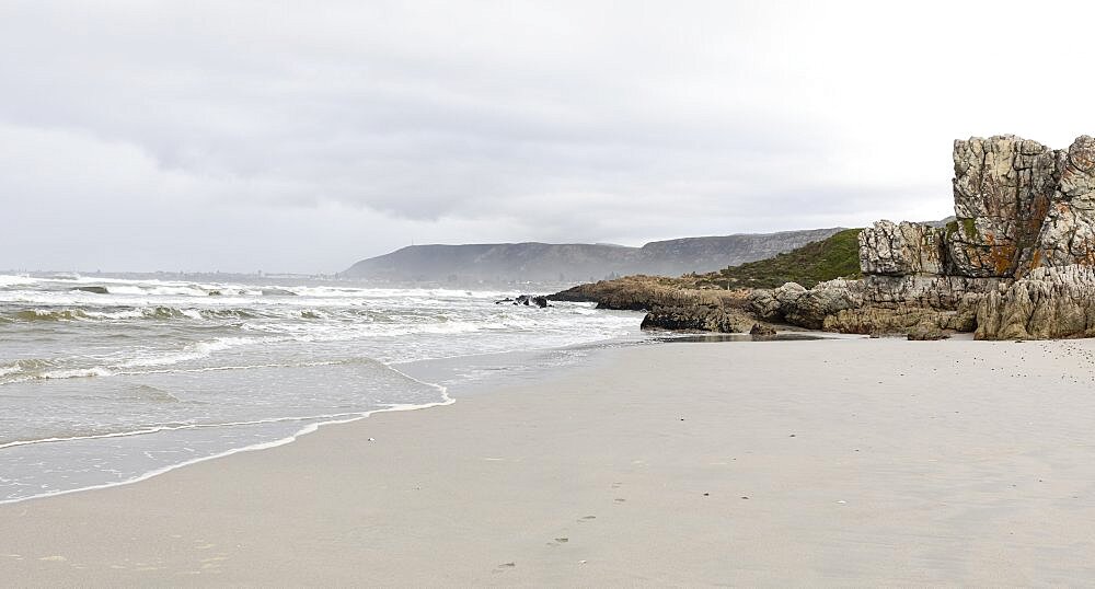 The jagged rocks and coastline of the Atlantic coast at Grotto Beach, a wide beach near Hermanus, Grotto Beach, Western Cape, South Africa