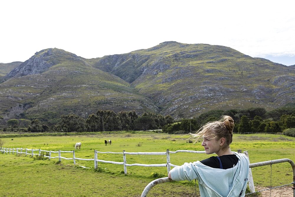 teenage girl looking at horses, Stanford, South Africa, Stanford, Western Cape, South Africa