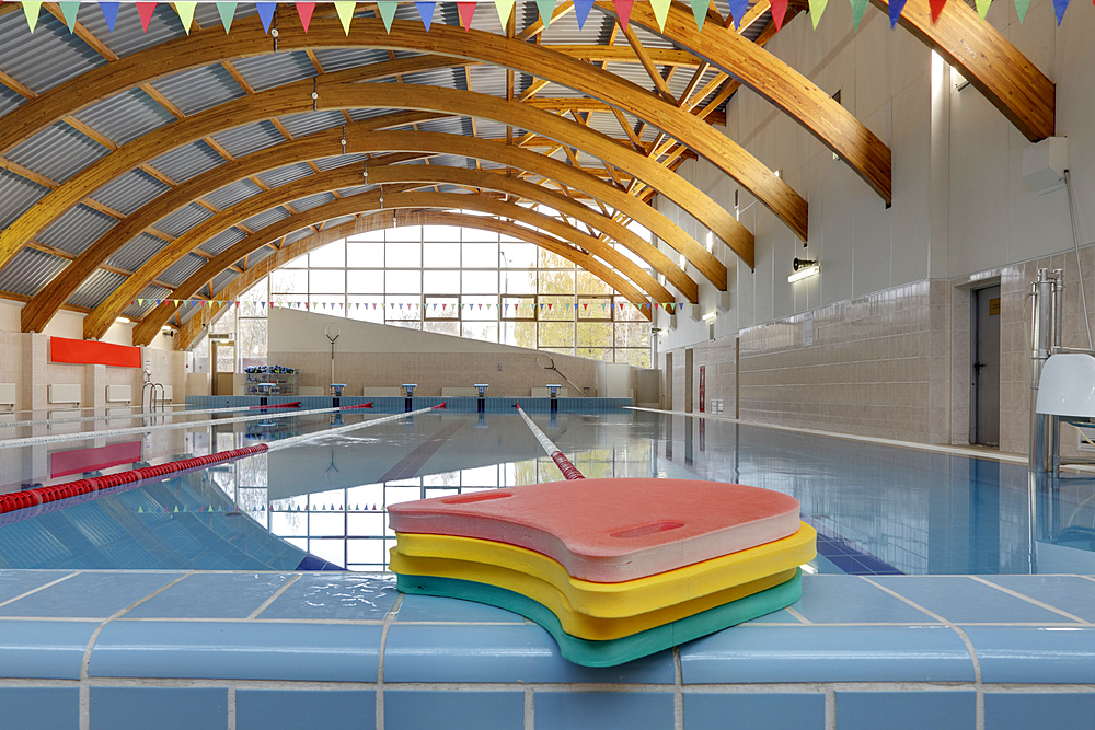 Indoor swimming pool, starting block, diving block and marked lanes, flat calm water