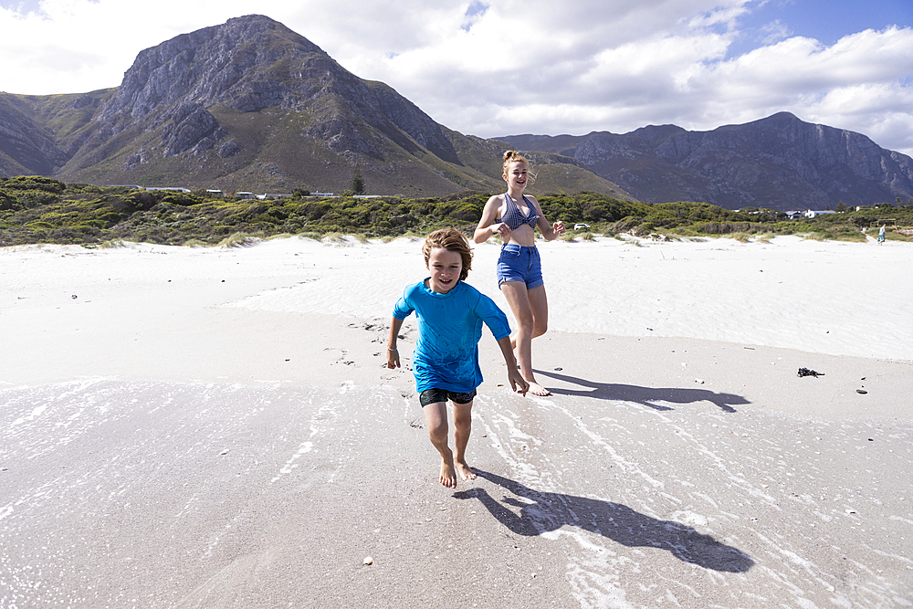 Children playing in surf, Grotto Beach, Hermanus, Western Cape, South Africa.