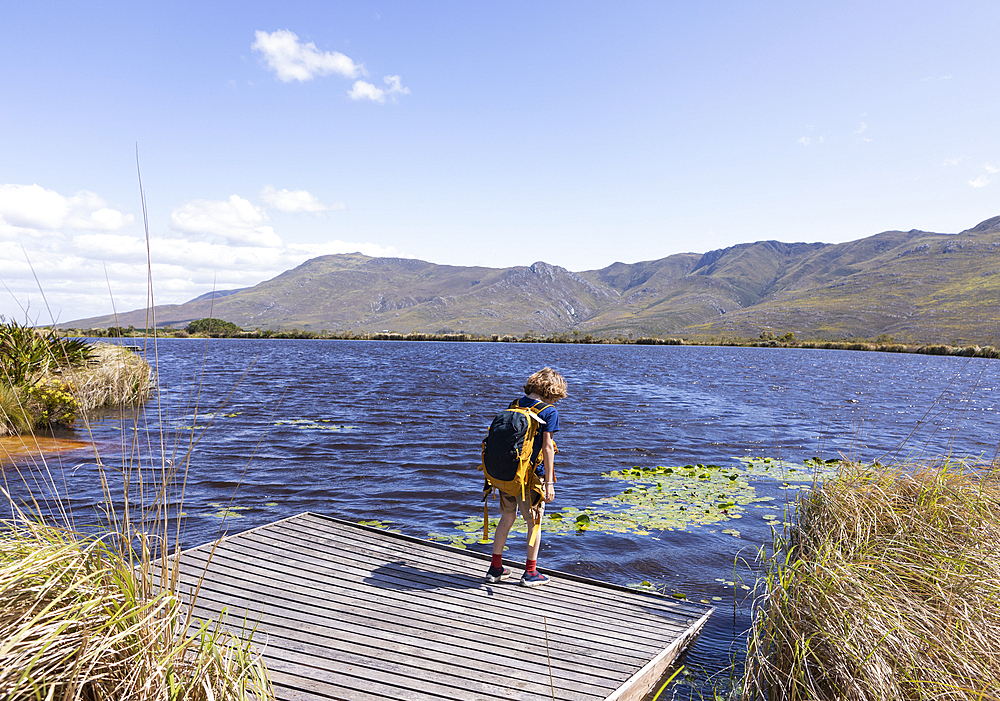 Young boy on boat launch, Stanford Valley Guest Farm, Stanford, Western Cape, South Africa.