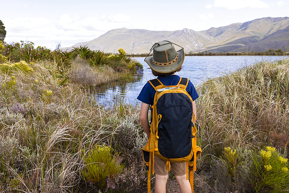 Young boy looking at pond, Stanford Valley Guest Farm, Stanford, Western Cape, South Africa.