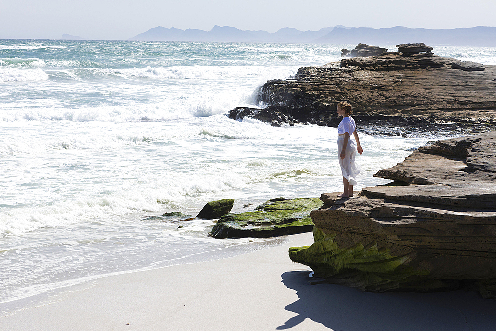 Teenage girl exploring Walker Bay Nature Reserve, Western Cape, South Africa.