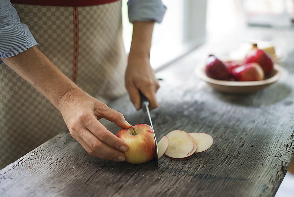 A person cutting up an organic apple, Woodstock, New York, USA