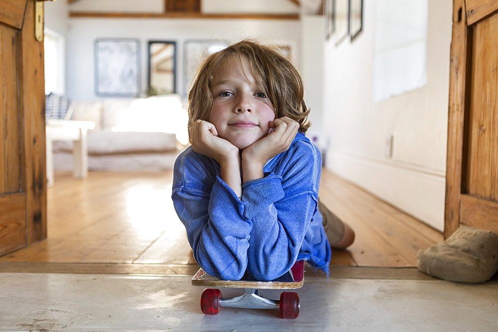 portrait of 8 year old boy with skateboard