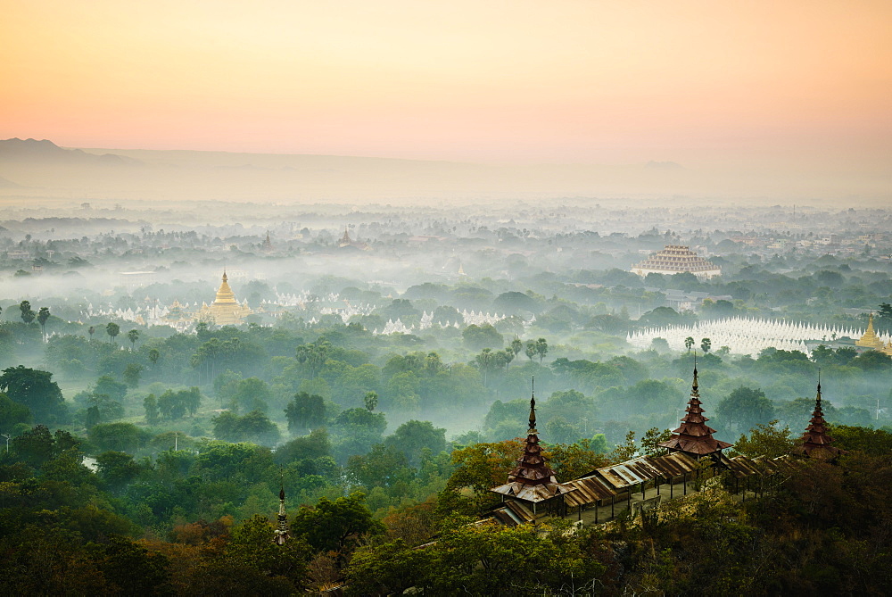 Elevated view of the plain of temples in Mandalay, stupas and spires emerging from the mist, historic Buddhist sites, Myanmar