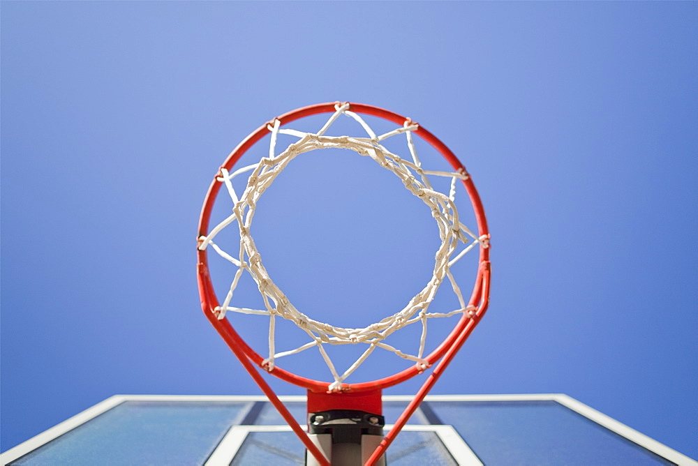 Basketball hoop, metal ring and netting, view from underneath.