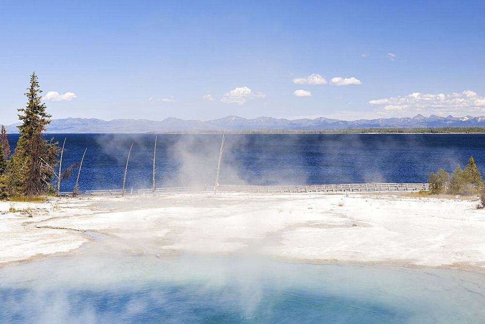 West Thumb geyser basin, a volcanic spring, steam rising from the water