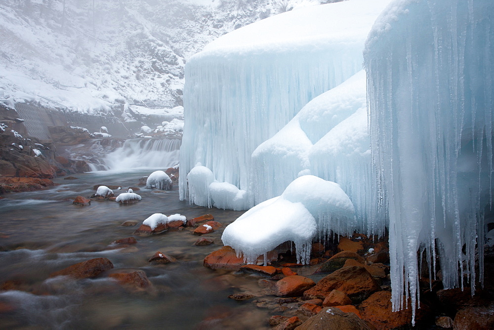 Honshu island, Nagano, Japan. Icicles and blocks of frozen snow by a stream, Honshu island, Nagano, Japan